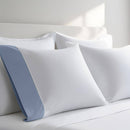 Pillow case with Blue color cuff displayed on a bed with white bedding
