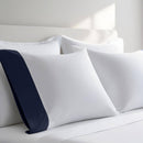 Pillow case with Navy color cuff displayed on a bed with white bedding